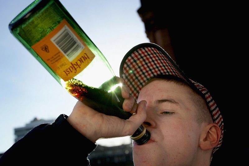 GLASGOW, SCOTLAND - JANUARY 27: A youth drinks Buckfast tonic wine on the banks of the River Clyde. January 27, 2005 in Glasgow, Scotland. The Scottish Executive has announced a major campaign designed to call time on the binge drinking culture which creates bad health and anti social behaviour. The UK government has announced that the drinks industry will pay towards policing town centres when 24 hour licensing is introduced in the UK later this year. It is estimated that drink related problems cost the people of Scotland over GBP1bn a year. Glasgow City Council has already banned "happy hours" where cut price drinks can be bought at specific times. (Photo by Christopher Furlong/Getty Images)