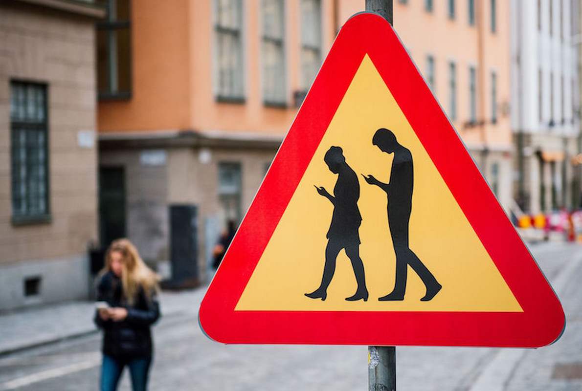 TOPSHOT - A road sign Warning Against pedestrians focusing on their smartphones is pictured on February 2, 2016 near the old town in Stockholm. / AFP / JONATHAN NACKSTRAND (Photo credit should read JONATHAN NACKSTRAND/AFP/Getty Images)