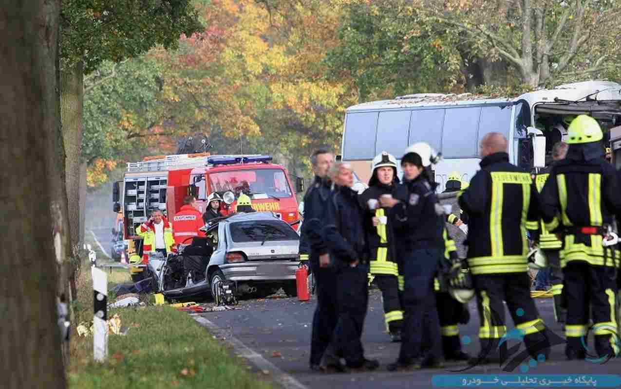Fireworkers stand at the scene of an accident at a road between Pessin and Friesack, eastern Germany, on October 18, 2014. The accident of a car colliding with a coach killed one person and injured 47. AFP PHOTO / DPA/ NESTOR BACHMANN GERMANY OUT (Photo credit should read NESTOR BACHMANN/AFP/Getty Images)
